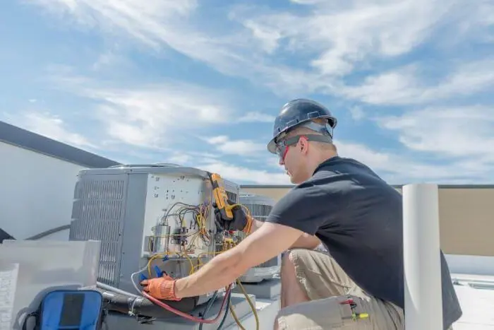 technician inspecting the outdoor units