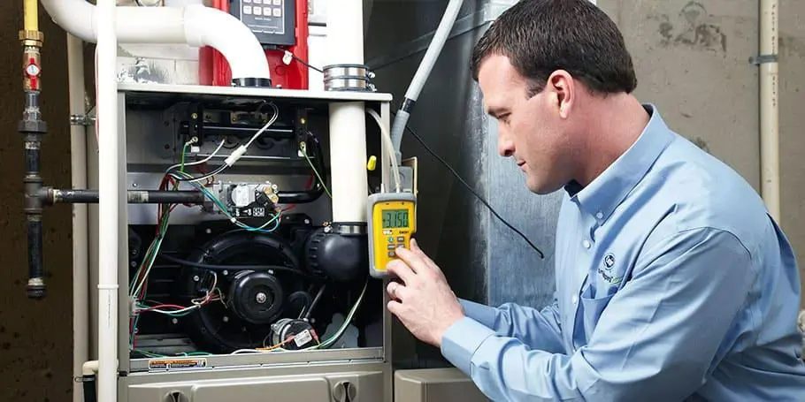A technician checking a heating unit